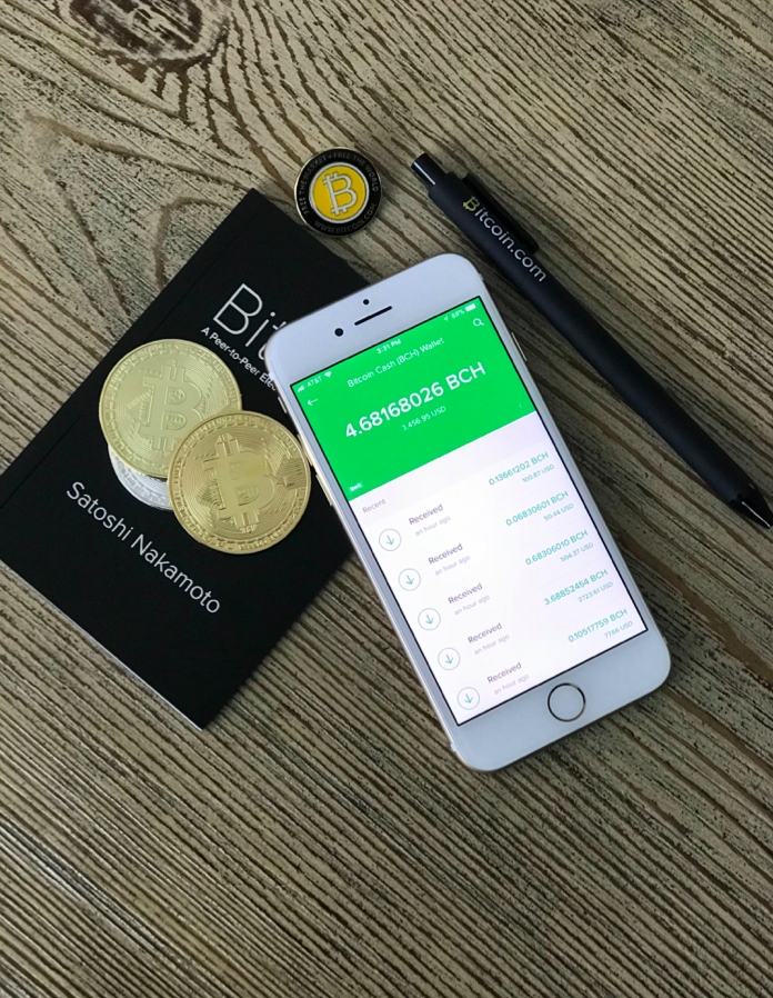 Bitcoin, phone and coins on the table